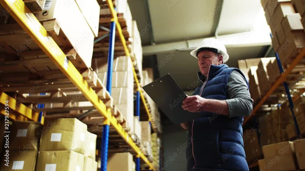 Portrait of a senior male warehouse worker or a supervisor. Portrait of a senior male warehouse worker or a supervisor.
