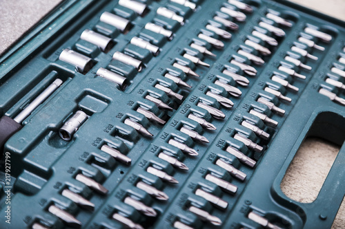 Set of metal heads for screwdriver in green box photo