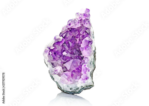 Violet Crystal Stone macro mineral. Purple rough Amethyst quartz crystals geode on white background, Uruguay