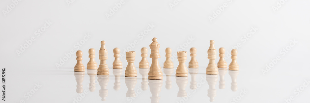 Wide panorama image of queen and chess pieces Wide panorama image of queen and chess pieces