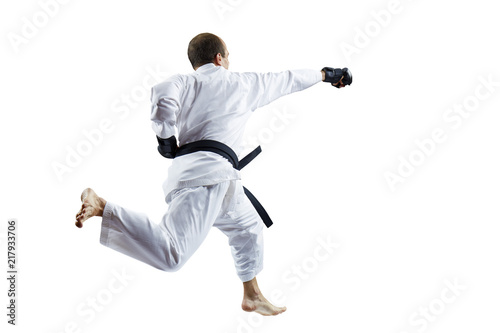 Adult athlete beats with a hand in a jump against a white background isolated