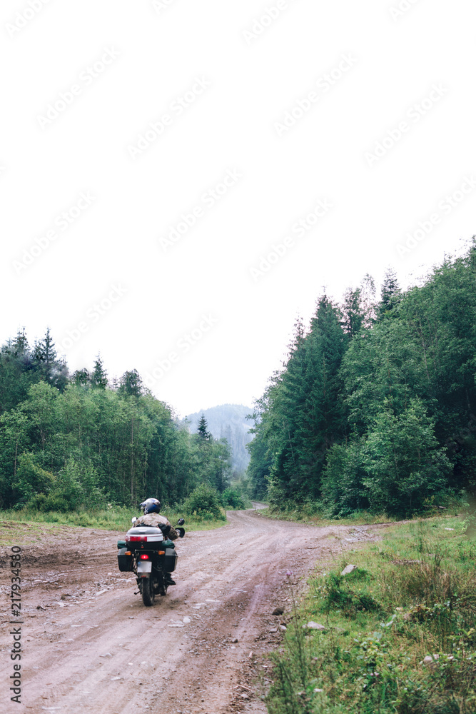 Motorcyclist man ride on Adventure Motorbike with beautiful mountains dirt road. Motorcycle trip. off road Traveling, Lifestyle Travel vacations sport outdoor concept vertical photo Motorcyclist man ride on Adventure Motorbike with beautiful mountains dirt road. Motorcycle trip. off road Traveling, Lifestyle Travel vacations sport outdoor concept vertical photo