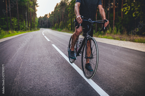 Road bike cyclist, man cycling on empty road in sunset  © Aleksandrs Muiznieks