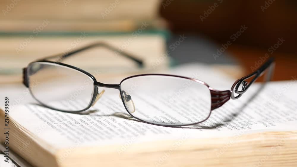 Glasses on the book highlighting with light Glasses on the book highlighting with light