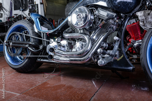 Detail on a modern motorcycle in the workshope. Motorcycle Exhaust. selective focus © Georgii