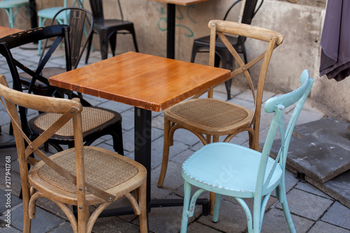 View of empty outdoor terrace cafe outdoor with retro wooden chairs and table in sunny summer day