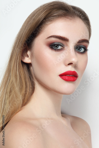Young beautiful girl with smoky eye makeup and red lips
