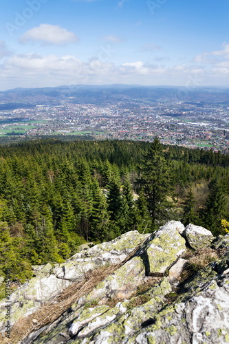 Rock formation Virive kameny - Whirling Stones under Jested mountain peak with Liberec city in background, Czech Republic, sunny summer day photo