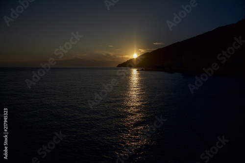 beautiful sea sunset behind the mountain