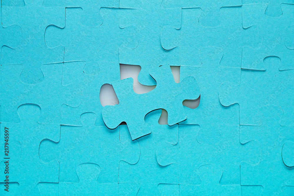 Puzzles on a white background. One element in the middle separately.