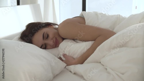 Happy Woman Waking Up In Comfortable Bed With White Linens