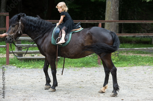 Girl ride on horse on summer day