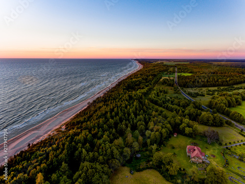 Drone image. aerial view of red sunset in the sea beach. shore line. baltic sea at dust - vintage retro look