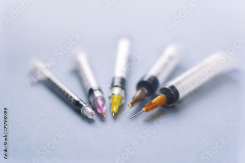 different needles on syringes. closeup. bokeh