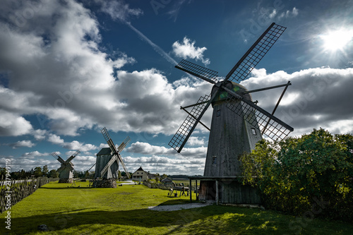 View towards Collection of old windmills at Angla Windmill Hill on a sunny day with blue sky and clouds in Saaremaa, Estonia photo