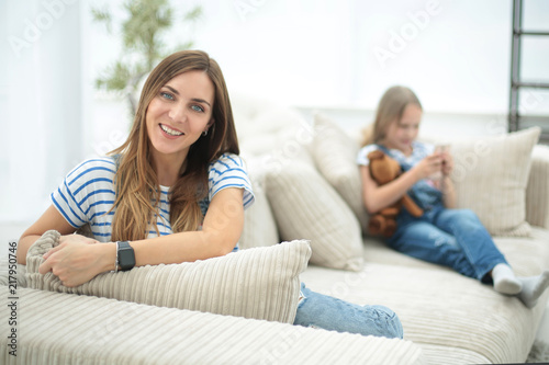 young housewife sitting in new living room