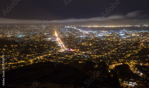 Night view of San Francisco Bay Area with Bay Bridge and Market Street illuminated
