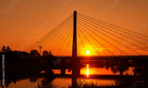 Steel cable bridge at sunrise over the river elbe