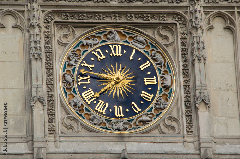 A blue clock with roman numerals