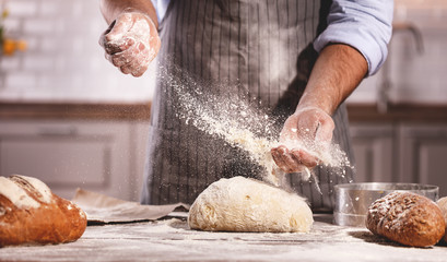 Papier peint photo Boulangerie Mains du boulanger pétrissant la pâte  © JenkoAtaman