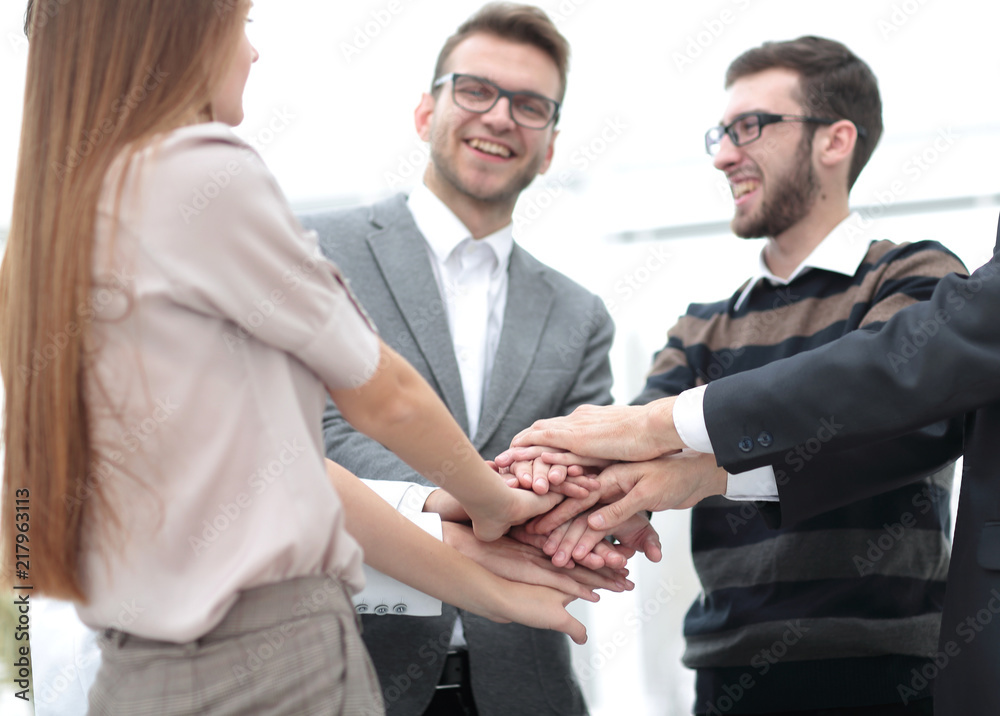 Business team standing joining hands together