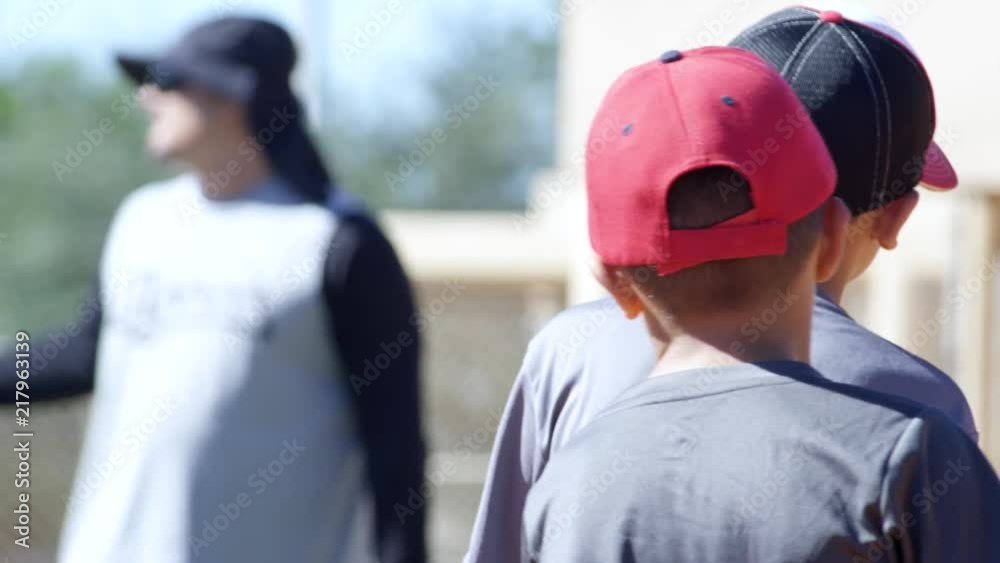 Slow motion of kids standing around during baseball practice Slow motion of kids standing around during baseball practice
