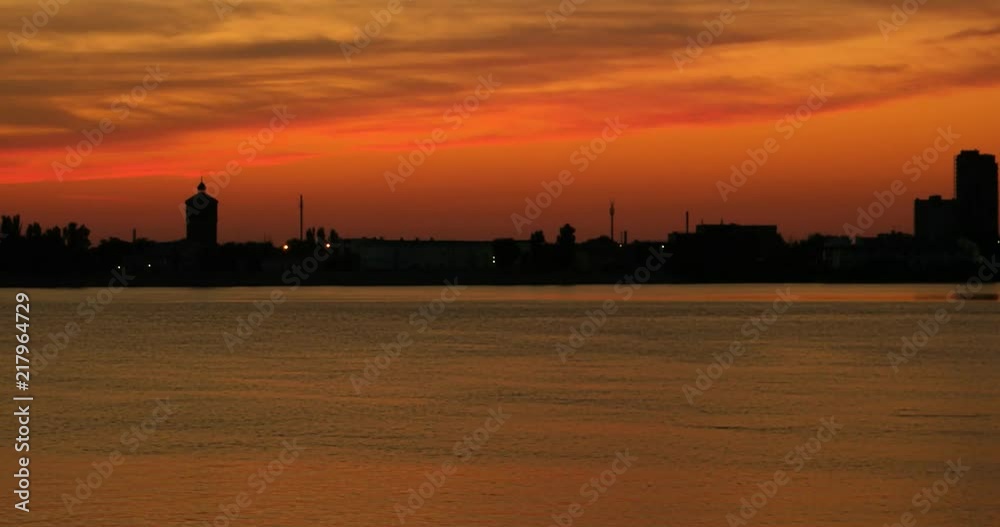 Summer sunset cityscape panorama 4k time lapse. Amazing view of sun setting in water Summer sunset cityscape panorama 4k time lapse. Amazing view of sun setting in water