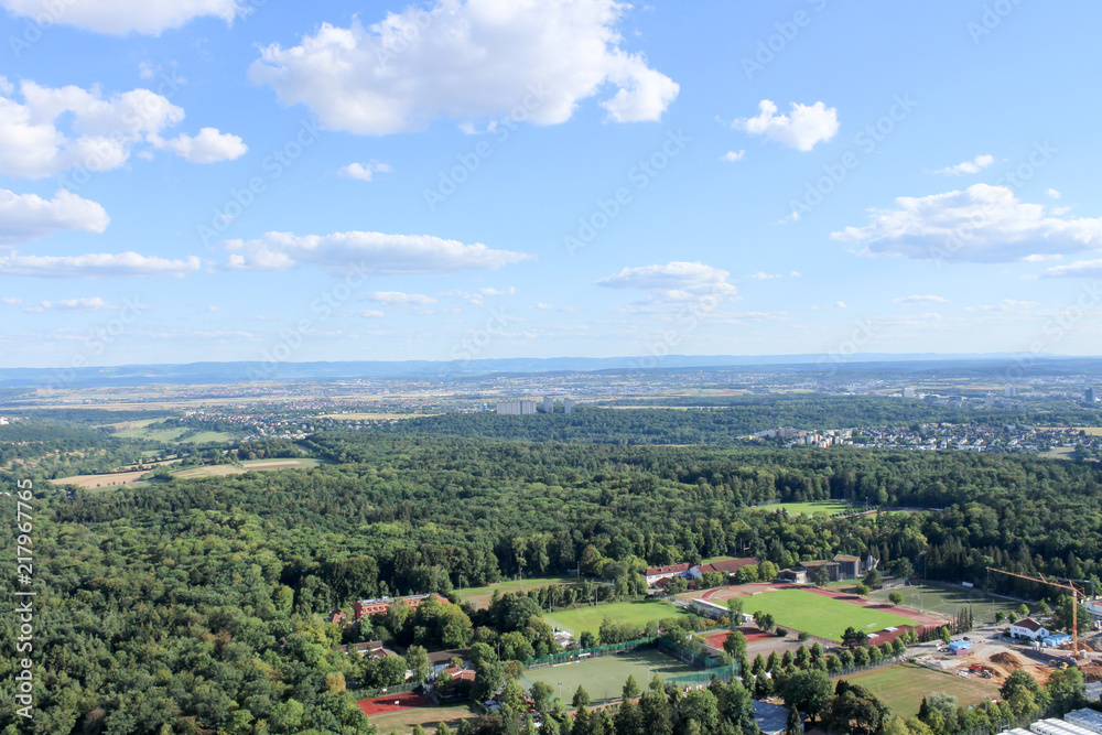 Obraz premium Amazing Landscape view on the beautiful forests, alpine mountains and idyllic fields of South Germany with a blue sky before sunset with clouds