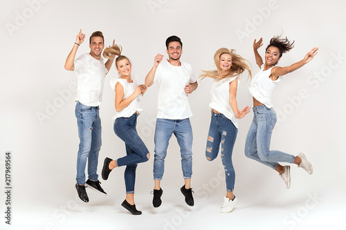 Group of smiling people jumping,having fun together.