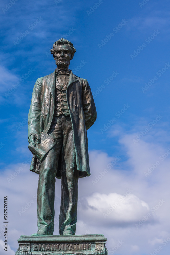 Edinburgh, Scotland, UK - June 13, 2012: Just the Abraham Lincoln bronze statue on Old Calton Cemetery isolated against blue cloudy sky.