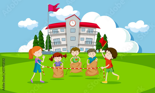 Young children having a potato sack race