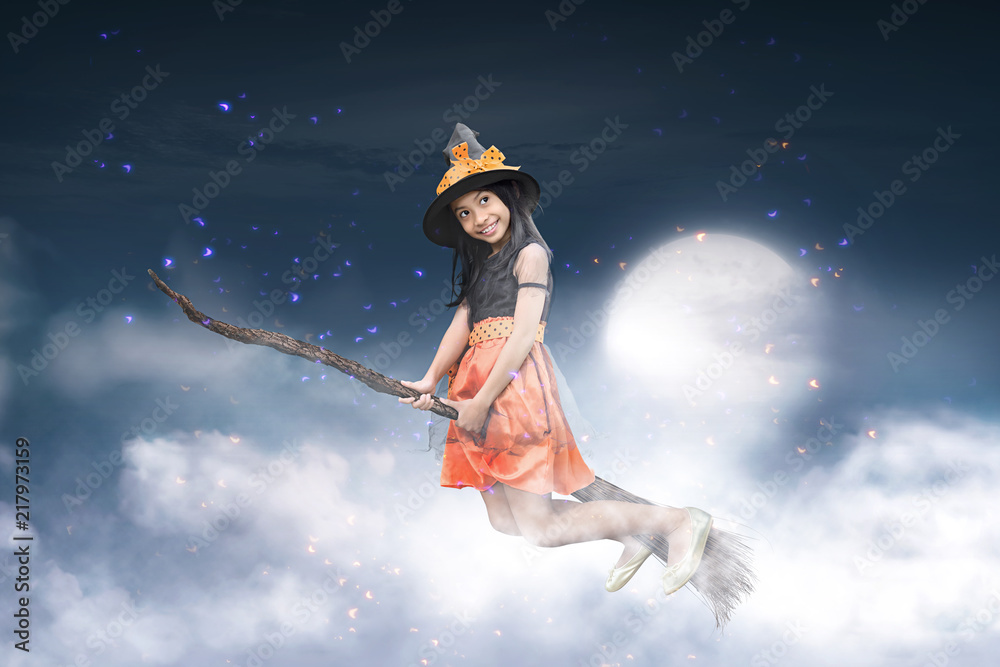 Obraz premium Happy asian witch girl flying on broomstick