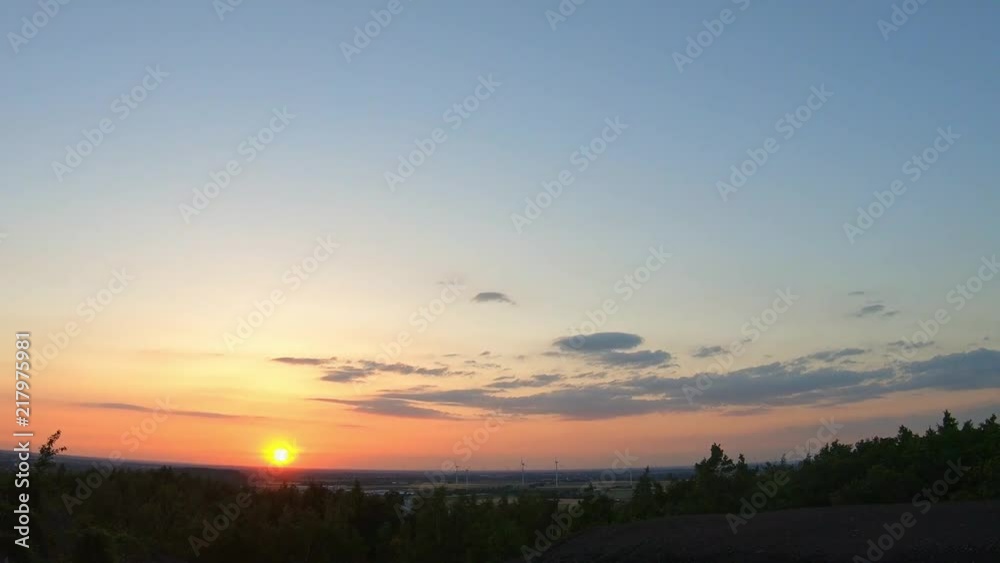 Timelapse of sunset with a wind farm in the background