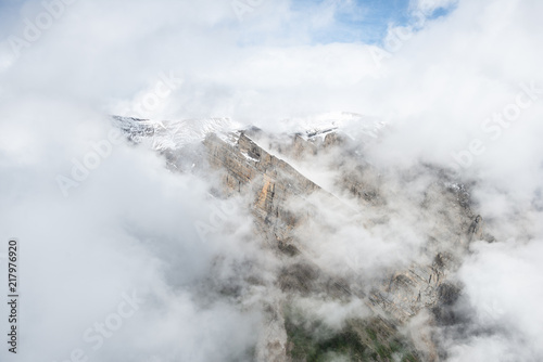 Flying through clouds and mountains in Wrangell-St.Elias National Park, Alaska photo