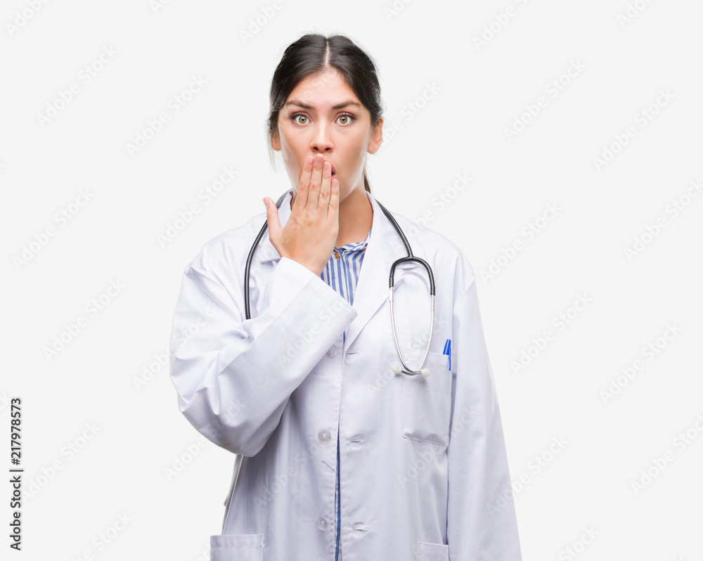Young hispanic doctor woman cover mouth with hand shocked with shame for mistake, expression of fear, scared in silence, secret concept Young hispanic doctor woman cover mouth with hand shocked with shame for mistake, expression of fear, scared in silence, secret concept