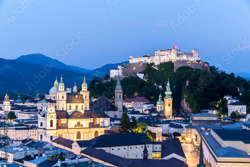Salzburg Cathedral and famous Festung Hohensalzburg illuminated in twilight