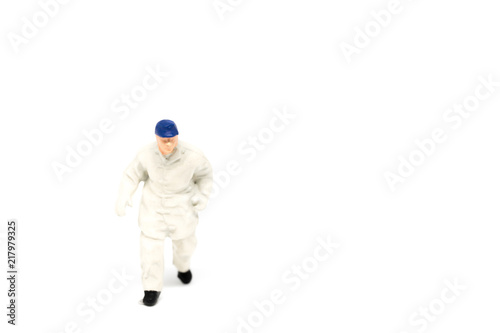 Miniature people firemen construction concept on white background with a space for text © pigprox