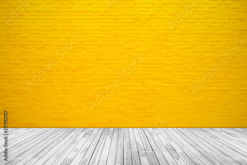 Yellow brick wall texture with wood floor background