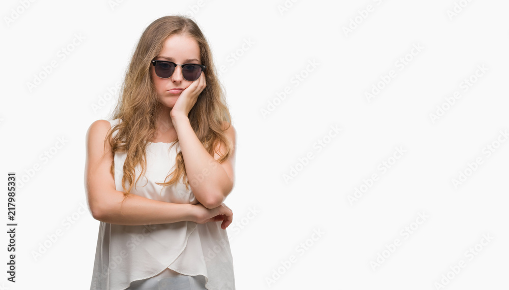 Young blonde woman wearing sunglasses thinking looking tired and bored with depression problems with crossed arms. Young blonde woman wearing sunglasses thinking looking tired and bored with depression problems with crossed arms.