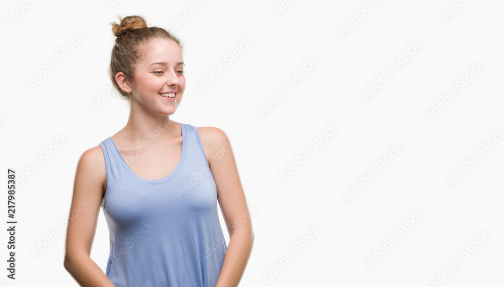Young blonde woman looking away to side with smile on face, natural expression. Laughing confident. Young blonde woman looking away to side with smile on face, natural expression. Laughing confident.
