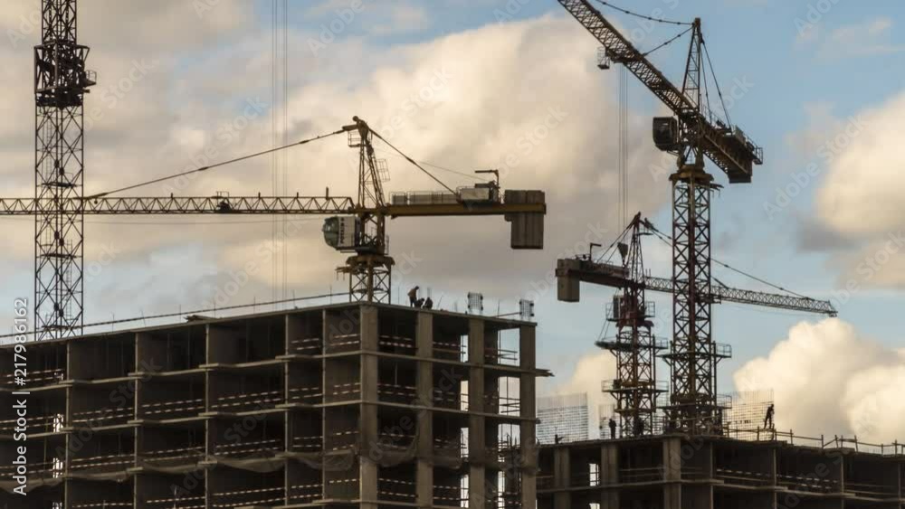 Cranes working day and night on construction of the housing estate in former industrial zone, time lapse Cranes working day and night on construction of the housing estate in former industrial zone, time lapse