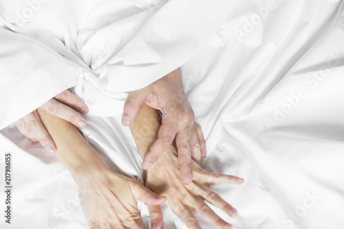 couple hands pulling white sheets in ecstasy  orgasm. Concept of passion. Oorgasm. Erotic moments. Intimate concept. Sex couple. Bedroom. Hotel room. Spa. Vacation