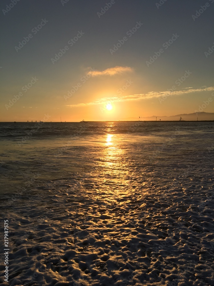 Sunset over the waves at Playa Del Rey Beach in Los Angeles California.