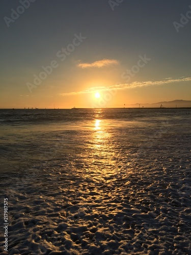 Sunset over the waves at Playa Del Rey Beach in Los Angeles California.
