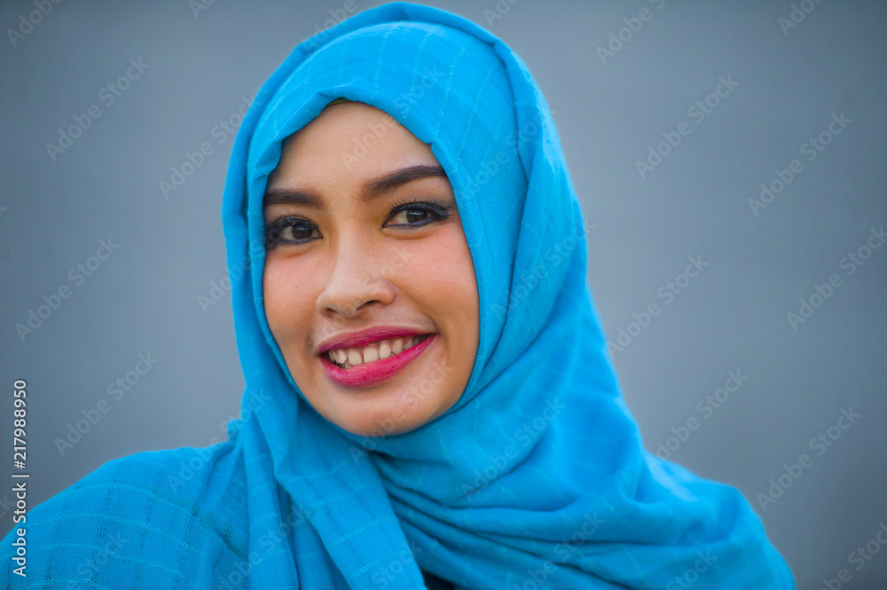 lifestyle isolated portrait of young beautiful happy Asian woman in hijab muslim head scarf posing to camera playful having fun smiling cheerful lifestyle isolated portrait of young beautiful happy Asian woman in hijab muslim head scarf posing to camera playful having fun smiling cheerful