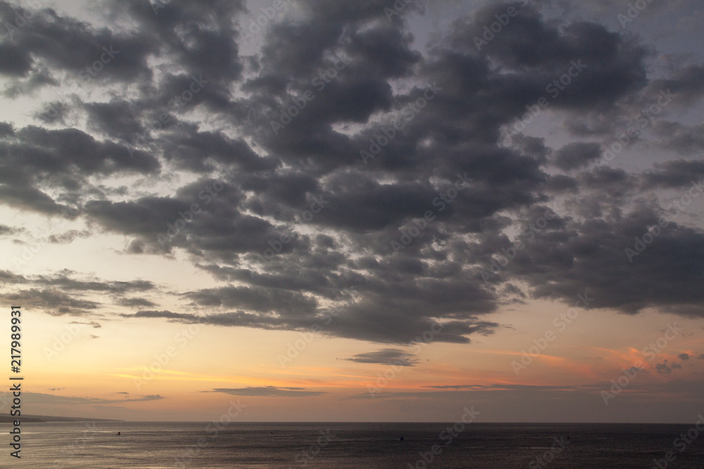 Large grey sunset clouds over the sea Large grey sunset clouds over the sea