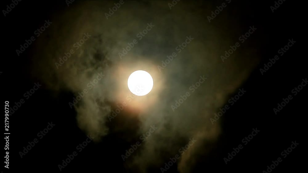 Time lapse of mystic full moon shining on the dark cloudy sky Time lapse of mystic full moon shining on the dark cloudy sky