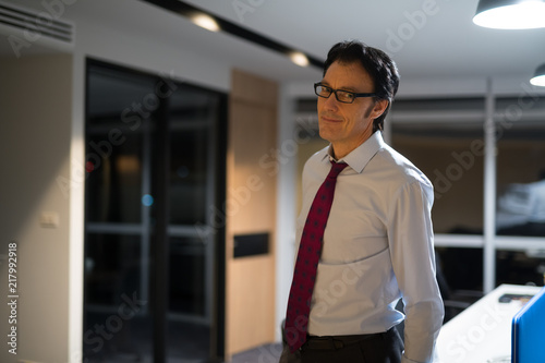 Mature Businessman In Office At Night