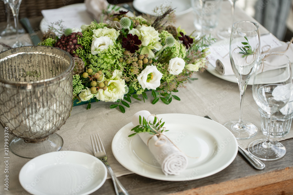 Wedding Banquet or gala dinner. The chairs and table for guests, served with cutlery and crockery. Covered with a linen tablecloth runner. party on terrace Wedding Banquet or gala dinner. The chairs and table for guests, served with cutlery and crockery. Covered with a linen tablecloth runner. party on terrace