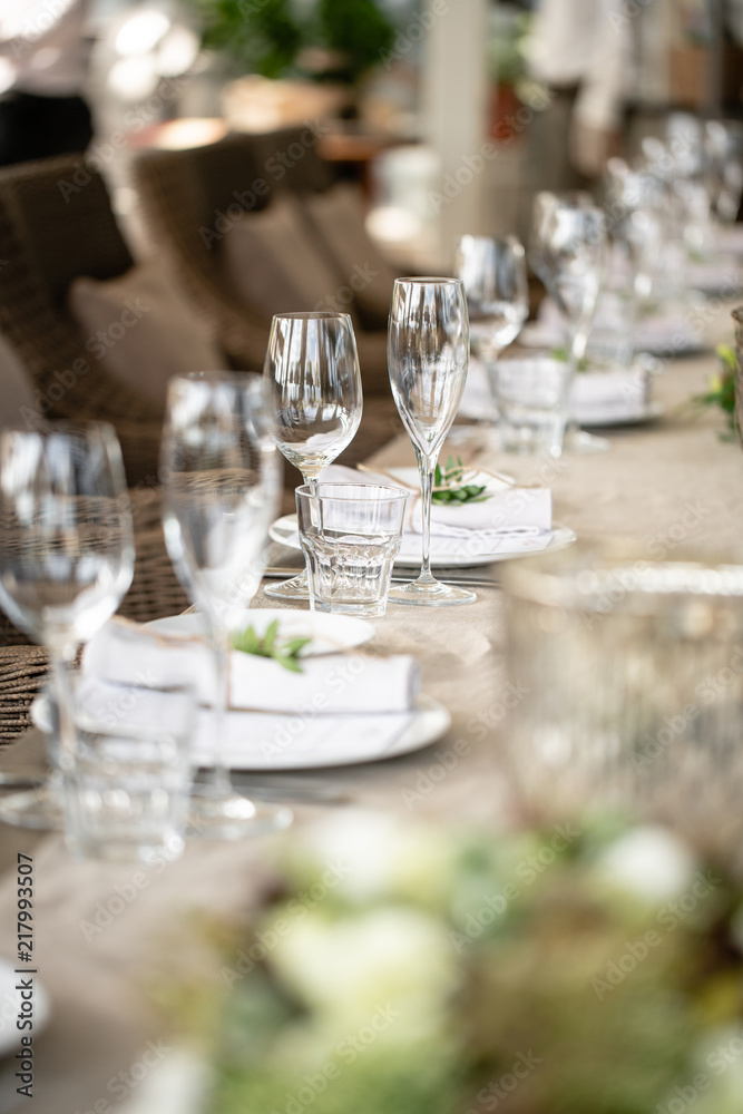 Wedding Banquet or gala dinner. The chairs and table for guests, served with cutlery and crockery. Covered with a linen tablecloth runner. party on terrace Wedding Banquet or gala dinner. The chairs and table for guests, served with cutlery and crockery. Covered with a linen tablecloth runner. party on terrace